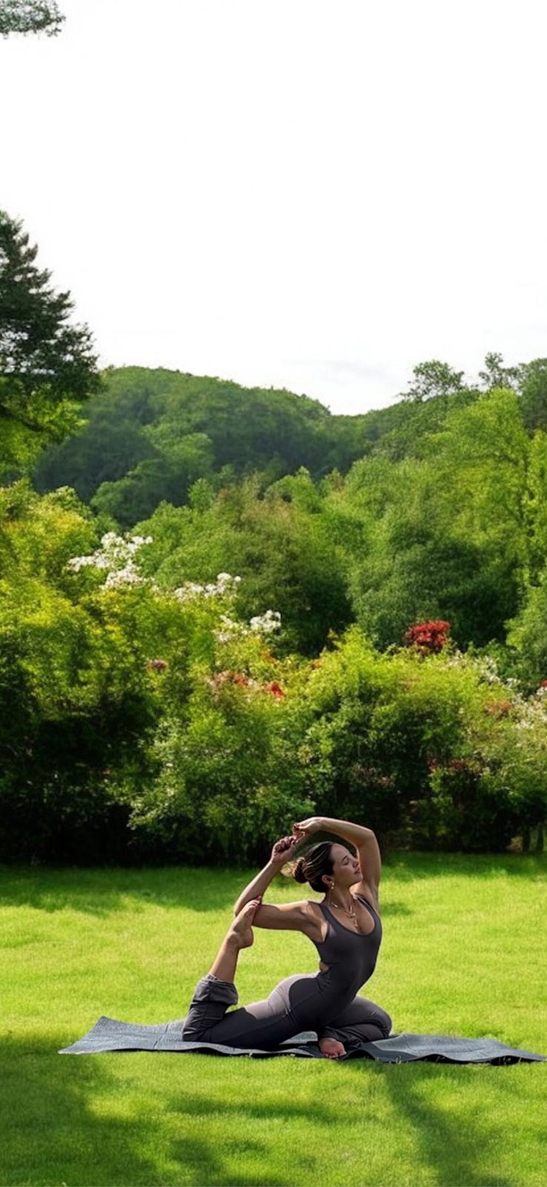 Miranda Sampedro practicing yoga outdoors in a garden